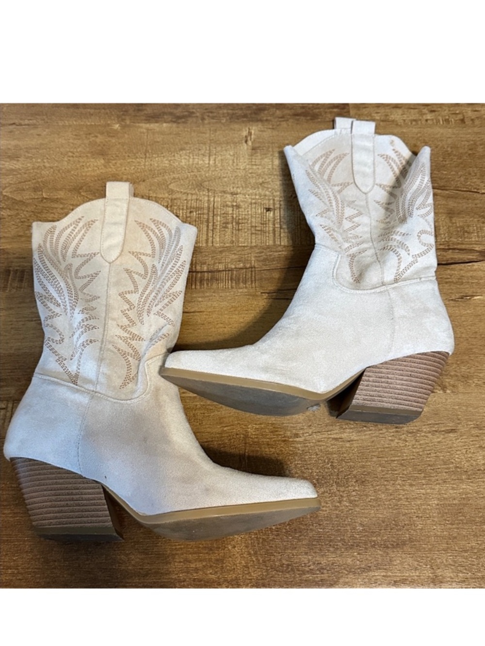 Elegant Suede Boots with intricate stitching detail.